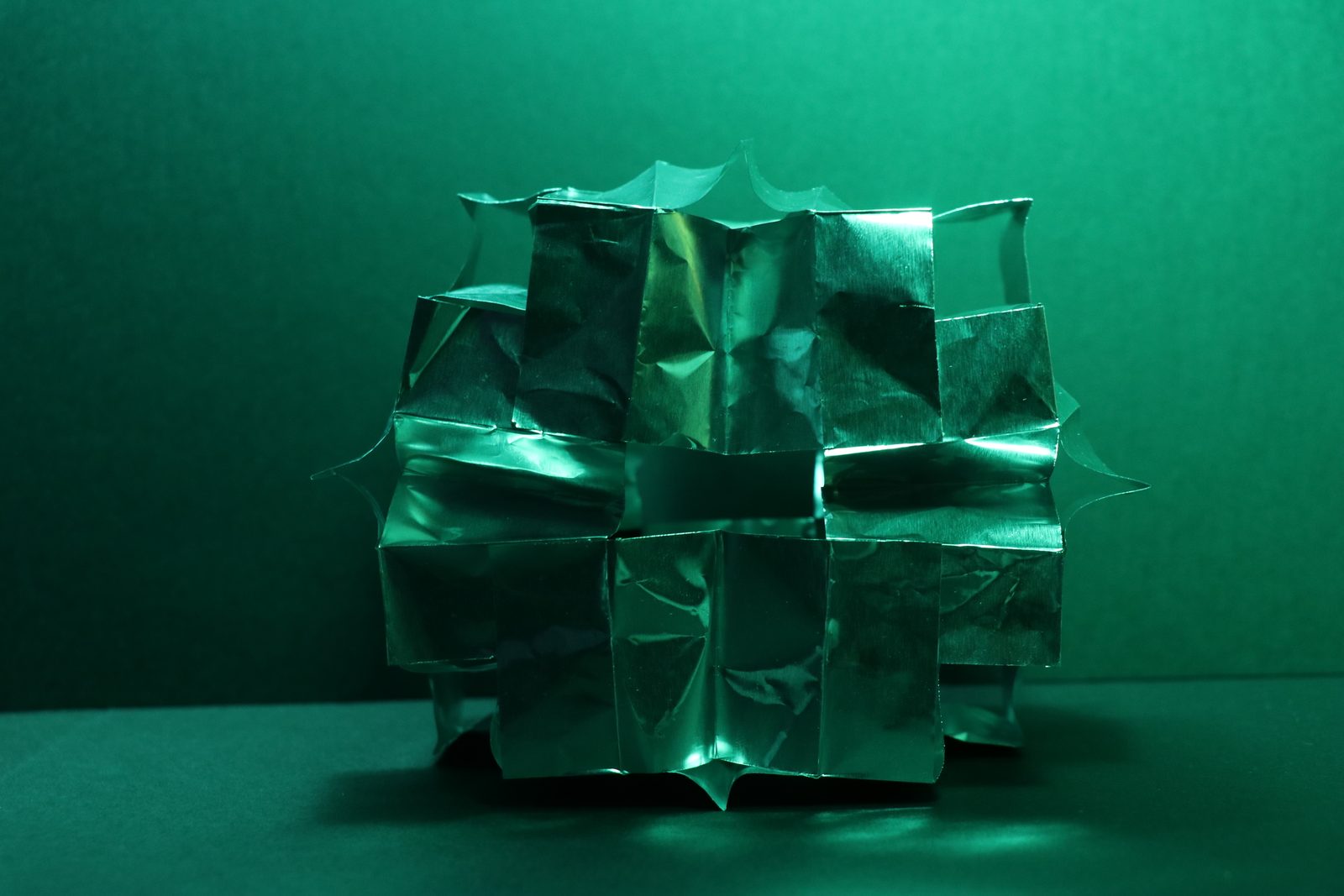 Folded paper form lit green on a green background.