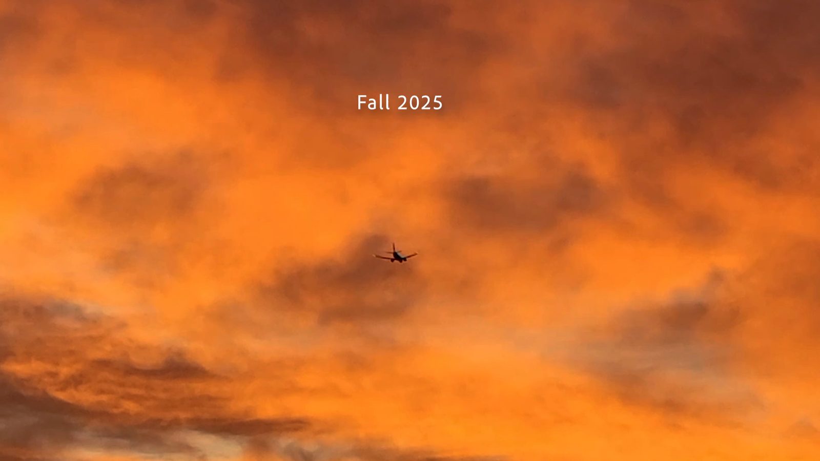 Film still: an orange sunset sky with a small plane crossing it, and the words Fall 2025.